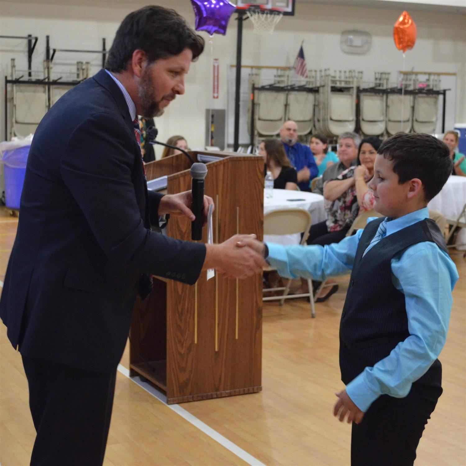  student shaking hand with assistant principal